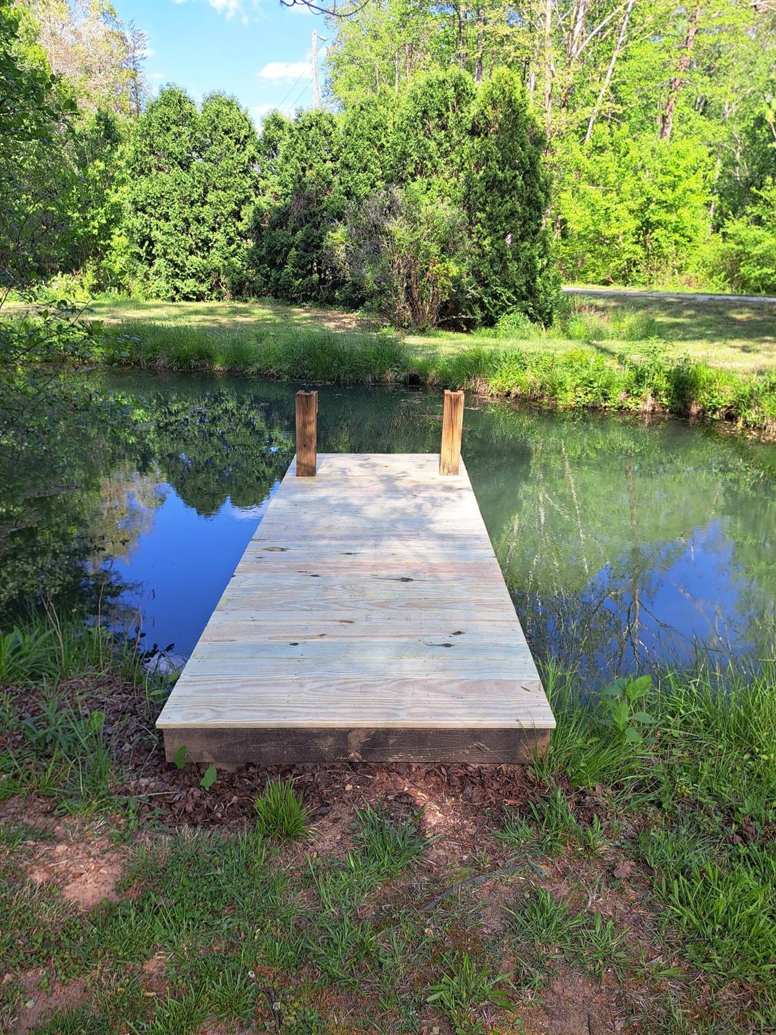 Rebuilt wooden dock over a pond